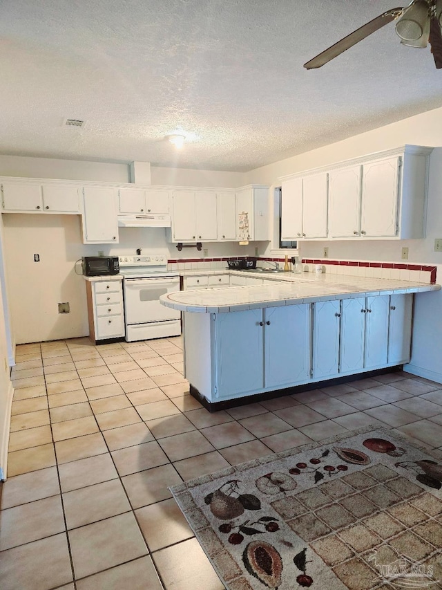 kitchen with white cabinetry, light tile patterned floors, electric range, ceiling fan, and a textured ceiling