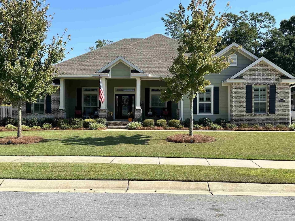 craftsman house with a front yard and a porch