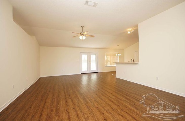8679 High School Blvd, Navarre, FL 32566 - unfurnished living room featuring dark wood-type flooring, visible vents, a ceiling fan, vaulted ceiling, and french doors