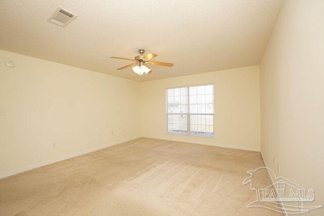 8679 High School Blvd, Navarre, FL 32566 - unfurnished room with ceiling fan, a textured ceiling, light carpet, visible vents, and baseboards