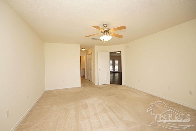 8679 High School Blvd, Navarre, FL 32566 - unfurnished room with light colored carpet, ceiling fan, a textured ceiling, and baseboards