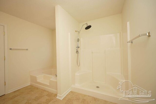 8679 High School Blvd, Navarre, FL 32566 - full bathroom featuring a garden tub, walk in shower, and baseboards