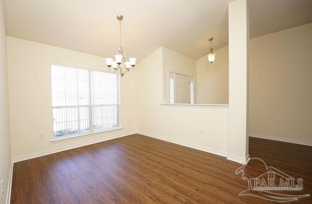 8679 High School Blvd, Navarre, FL 32566 - empty room featuring lofted ceiling, dark wood finished floors, and baseboards