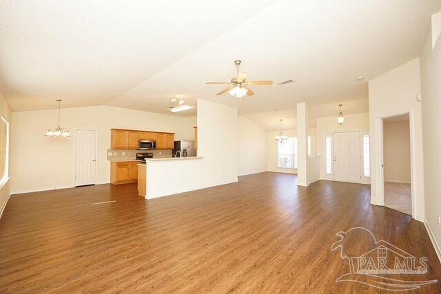 8679 High School Blvd, Navarre, FL 32566 - unfurnished living room with dark wood-style floors, lofted ceiling, visible vents, and ceiling fan with notable chandelier