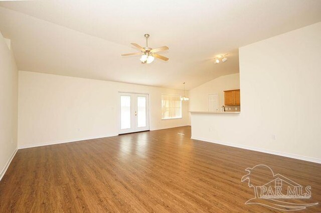 8679 High School Blvd, Navarre, FL 32566 - unfurnished living room featuring ceiling fan, wood finished floors, baseboards, vaulted ceiling, and french doors
