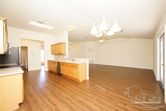 8679 High School Blvd, Navarre, FL 32566 - kitchen featuring stainless steel appliances, visible vents, open floor plan, wood finished floors, and a chandelier