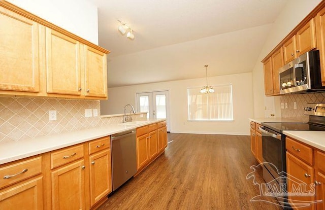 8679 High School Blvd, Navarre, FL 32566 - kitchen with french doors, stainless steel appliances, light countertops, dark wood-type flooring, and a sink