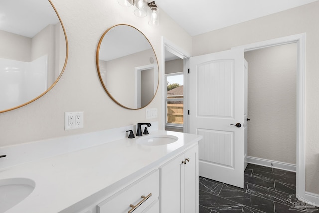 7917 Twin Lake Dr, Milton, FL 32583 - bathroom featuring marble look tile flooring and double vanity