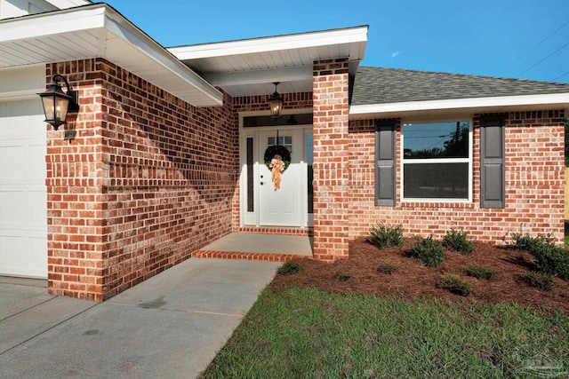 7917 Twin Lake Dr, Milton, FL 32583 - entrance to property featuring a garage, brick siding, and roof with shingles