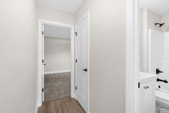 7917 Twin Lake Dr, Milton, FL 32583 - hall featuring a textured wall and wood finished floors