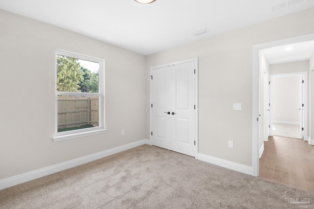 7917 Twin Lake Dr, Milton, FL 32583 - unfurnished bedroom featuring carpet and a closet