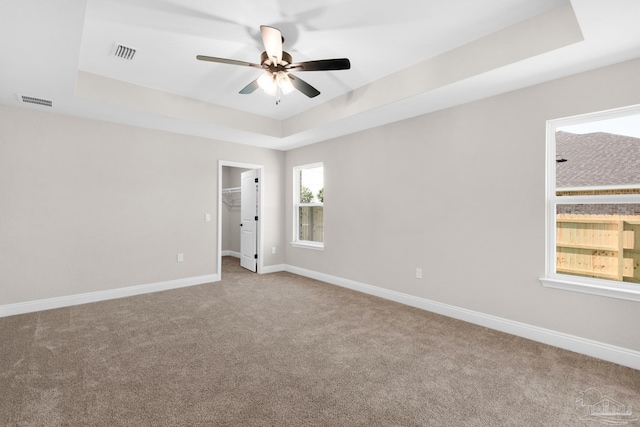 7917 Twin Lake Dr, Milton, FL 32583 - empty room featuring a raised ceiling, carpet, and ceiling fan