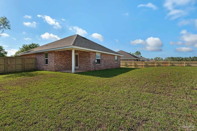 7917 Twin Lake Dr, Milton, FL 32583 - rear view of house with a fenced backyard, brick siding, and a patio