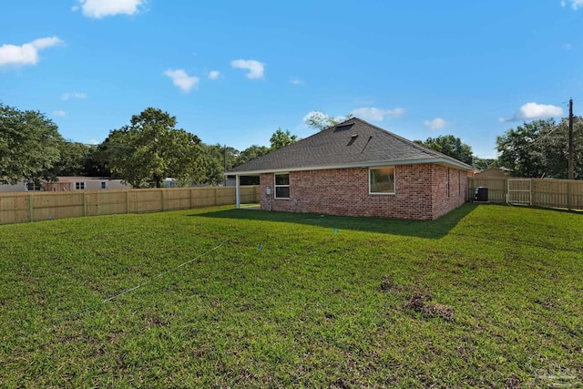 7917 Twin Lake Dr, Milton, FL 32583 - back of house featuring a fenced backyard, brick siding, and roof with shingles