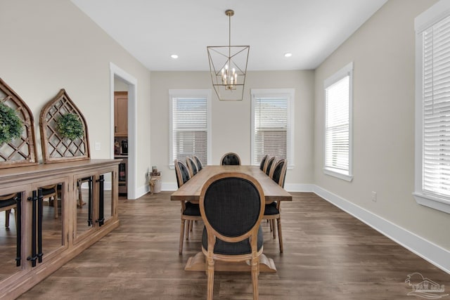 dining area featuring a chandelier and dark hardwood / wood-style floors