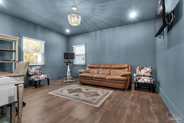 living room featuring a chandelier and wood-type flooring