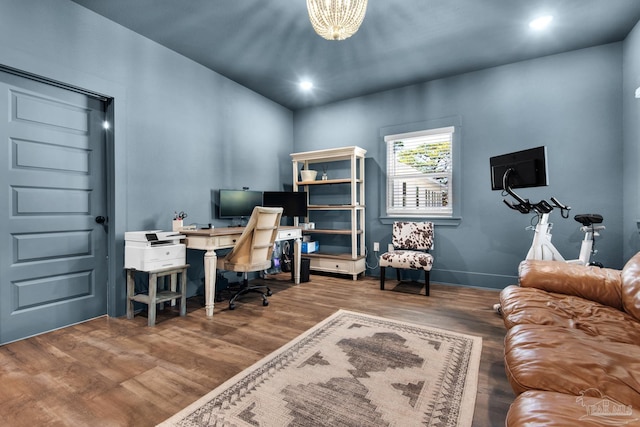 home office featuring wood-type flooring and a chandelier