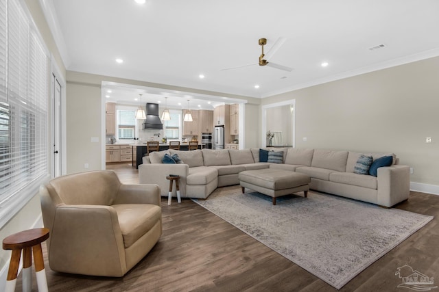 living room with ceiling fan, crown molding, and dark wood-type flooring