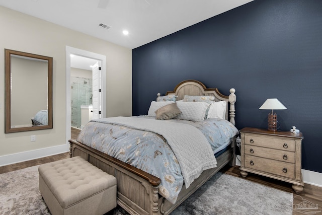 bedroom featuring ceiling fan, dark hardwood / wood-style floors, and ensuite bathroom