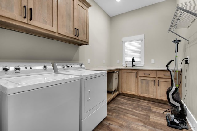 washroom featuring sink, separate washer and dryer, cabinets, and dark hardwood / wood-style floors