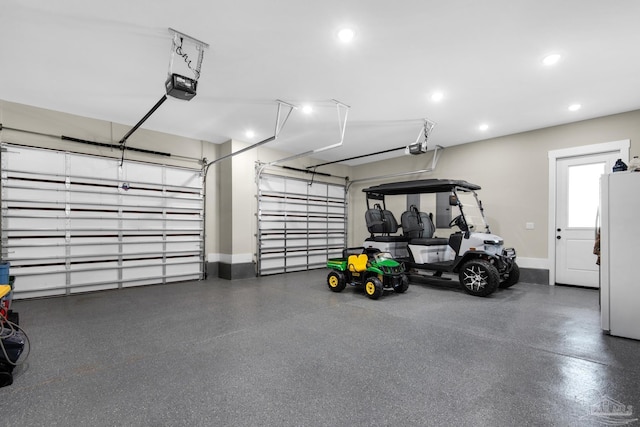 garage with white fridge and a garage door opener