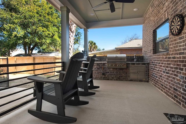 view of patio with area for grilling, sink, grilling area, and ceiling fan