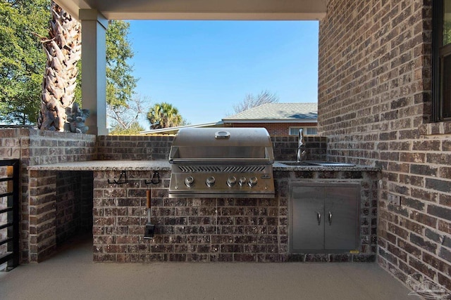 view of patio with sink, exterior kitchen, and grilling area