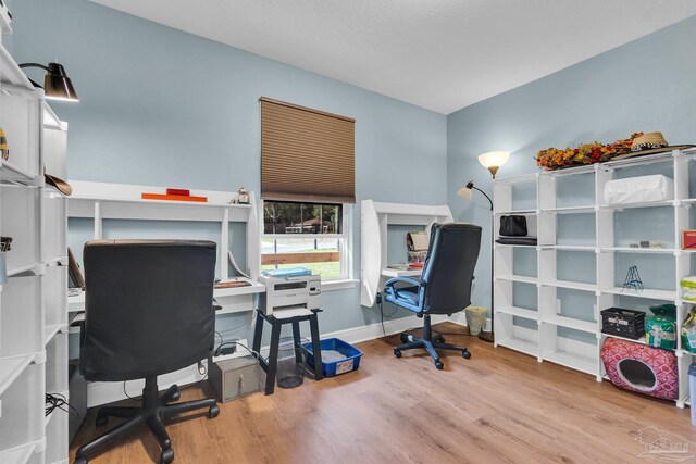 home office featuring baseboards and wood finished floors