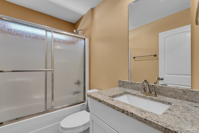 full bath with bath / shower combo with glass door, toilet, and vanity