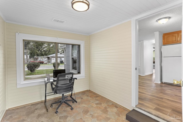 office featuring stone finish flooring, visible vents, wood walls, and ornamental molding