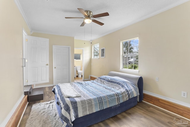 bedroom with baseboards, wood finished floors, a ceiling fan, and ornamental molding