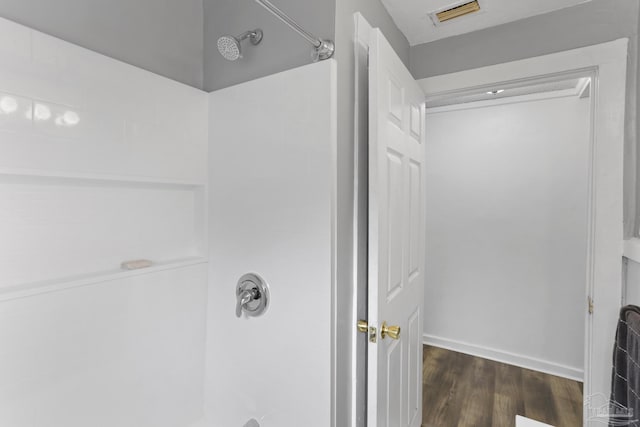 bathroom with visible vents, walk in shower, and wood finished floors