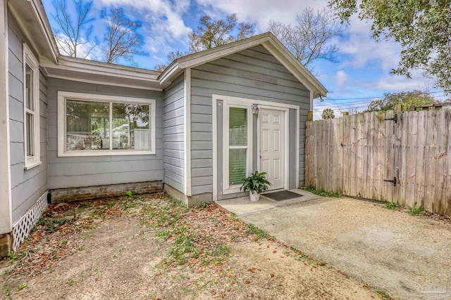 doorway to property with a patio area and fence