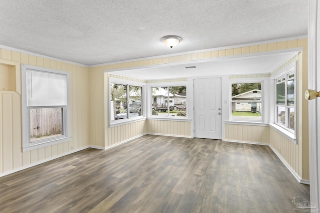 interior space featuring wood finished floors, a wealth of natural light, and a textured ceiling