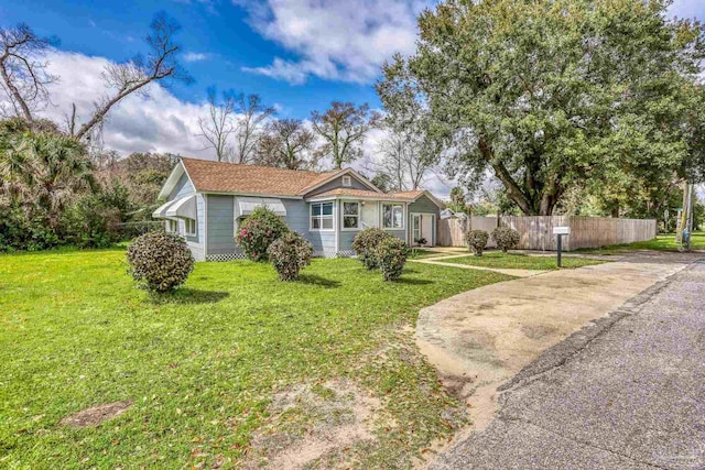 view of front of property with a front yard and fence