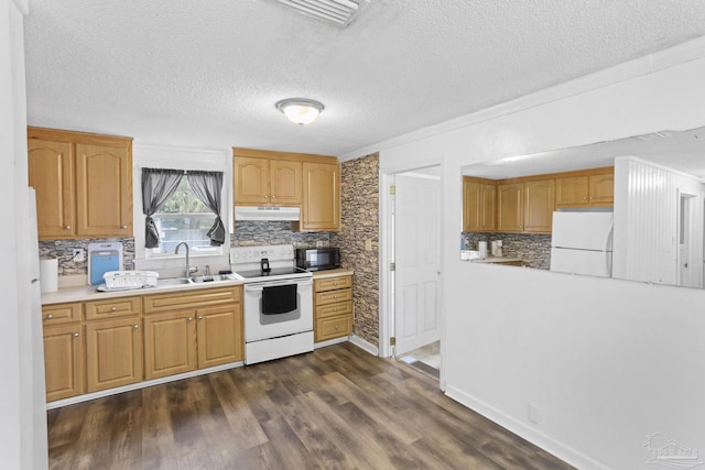 kitchen with white appliances, dark wood finished floors, a sink, light countertops, and under cabinet range hood