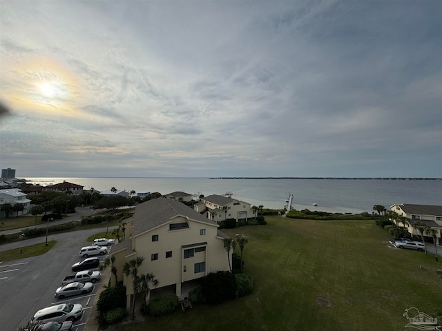 aerial view at dusk featuring a water view