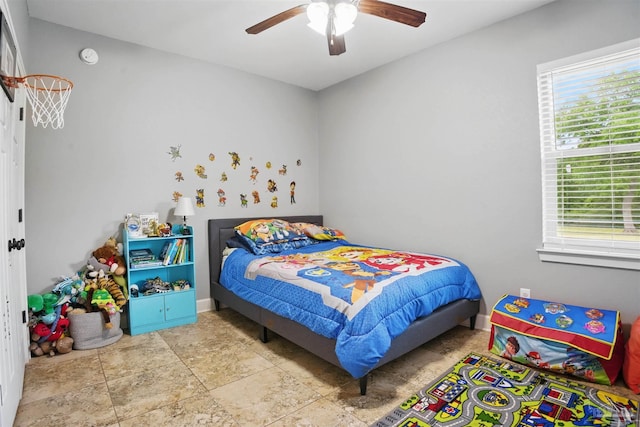 bedroom featuring stone finish flooring and a ceiling fan