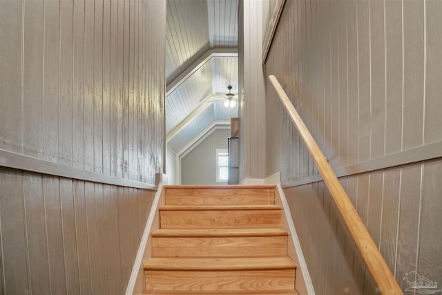 staircase featuring ceiling fan