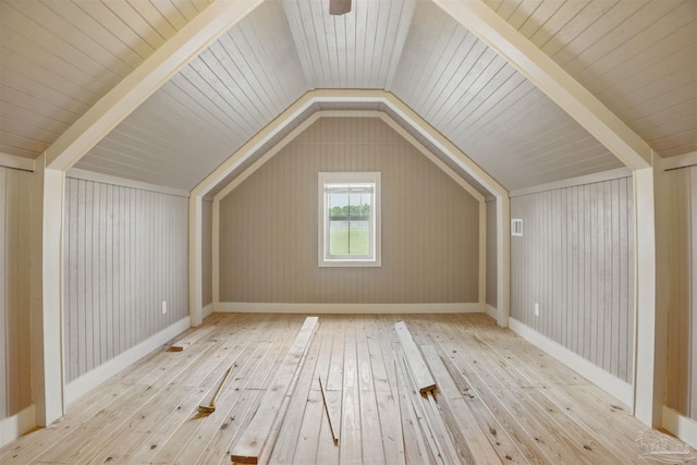 additional living space featuring lofted ceiling and wood-type flooring