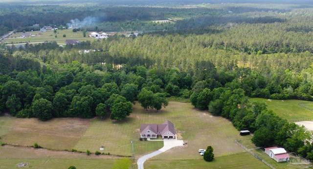 drone / aerial view with a wooded view
