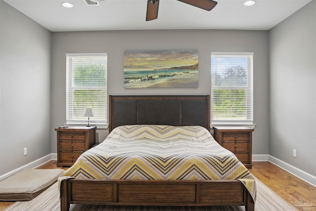 bedroom featuring baseboards, recessed lighting, and multiple windows