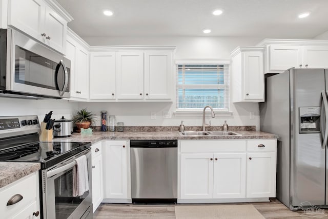 kitchen featuring white cabinetry, appliances with stainless steel finishes, and sink