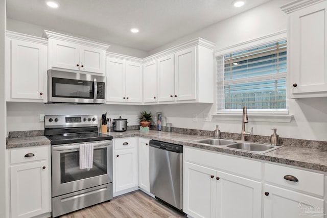 kitchen featuring white cabinets, sink, and appliances with stainless steel finishes