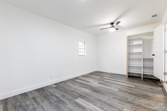 unfurnished bedroom with ceiling fan and hardwood / wood-style flooring