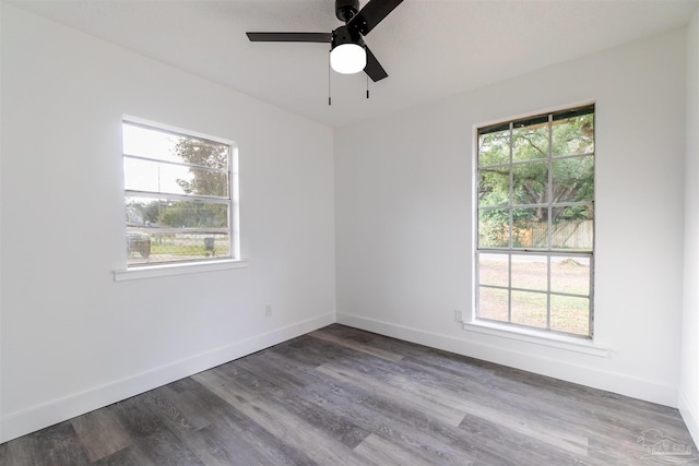 unfurnished room with ceiling fan and dark hardwood / wood-style flooring