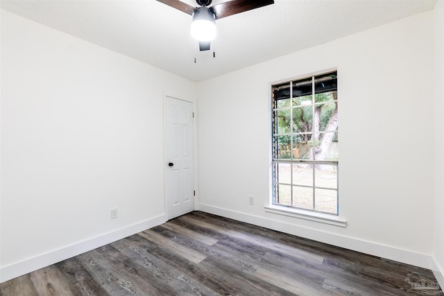 empty room featuring dark hardwood / wood-style flooring, plenty of natural light, and ceiling fan