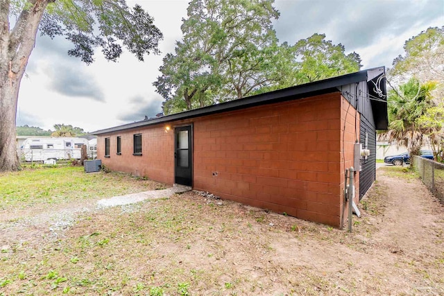 view of side of home with central air condition unit