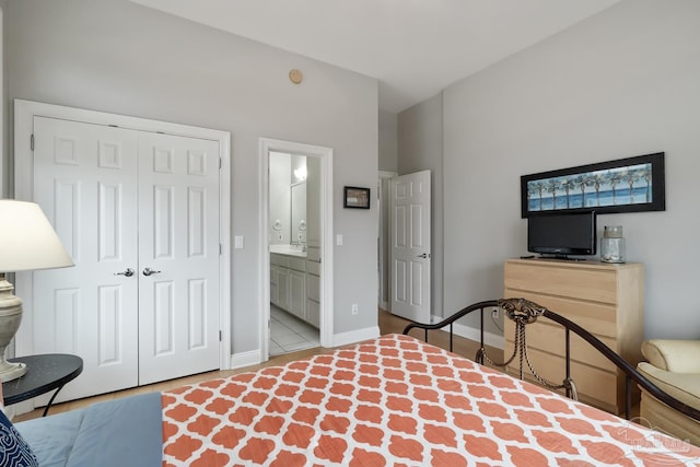 bedroom with ensuite bath and a closet