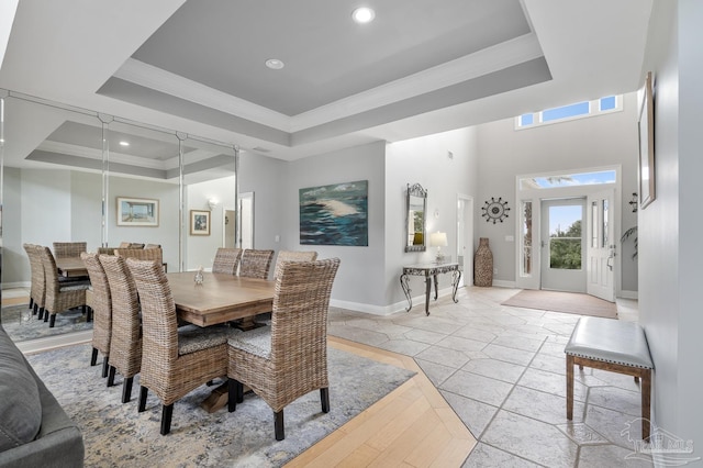 dining room with a raised ceiling and crown molding